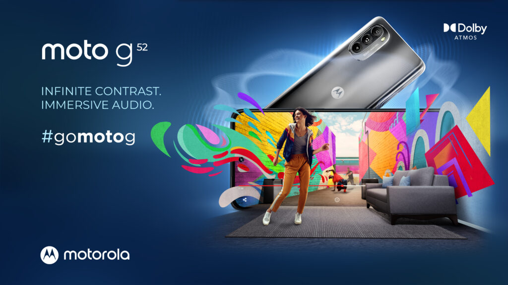 Moto G52 phone surrounded by colorful objects in a graphic room