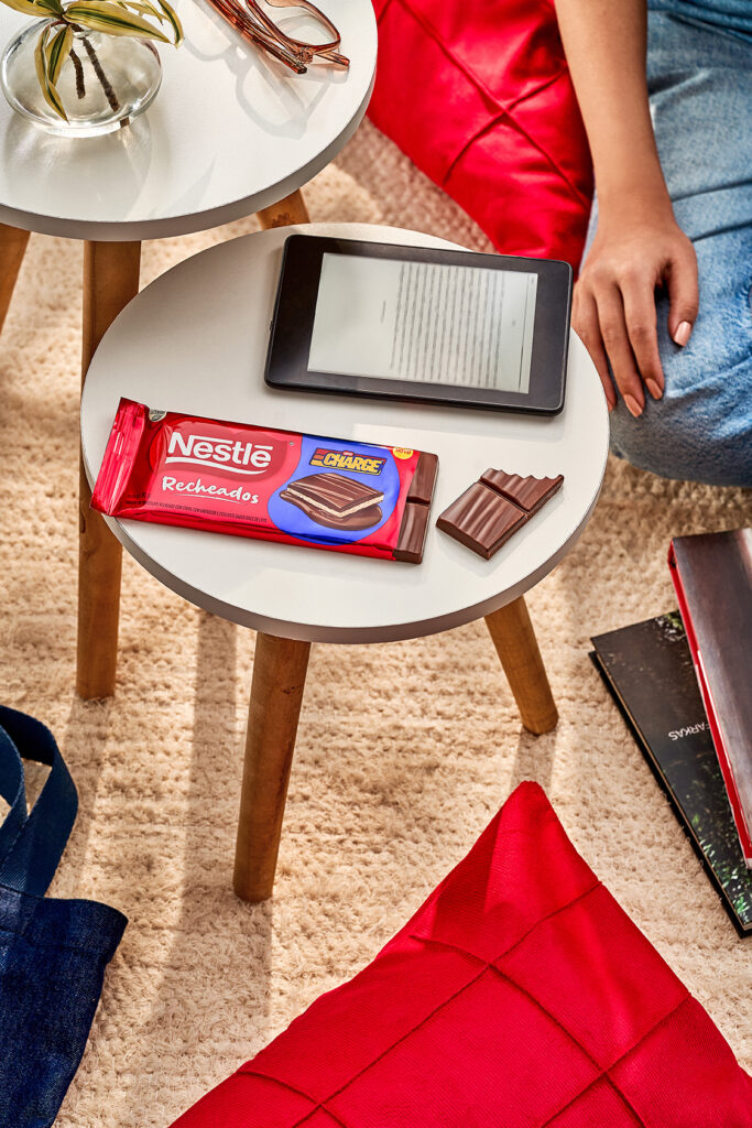 Nestle filled chocolate bar beside a tablet on a living room side table